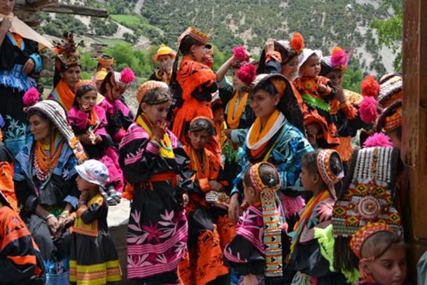 Femmes et enfants kalash en costume traditionnel brillant.