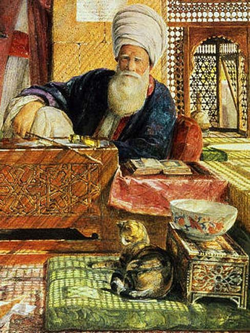Chat se reposant sur un oreiller à côté d'un imam au Caire.