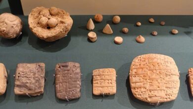 Clay accounting ball with calculi, counters, and evolution of cuneiform. Exhibit in the Oriental Institute Museum, University of Chicago, Chicago, Illinois, USA