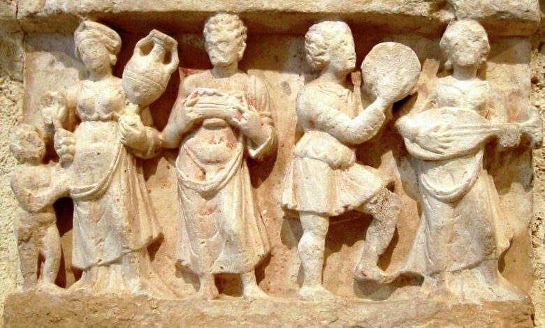 Hellenistic culture in the Indian subcontinent: Greek clothes, amphoras, win,e and music. Detail from Chakhil-i-Ghoundi Stupa, Hadda, Gandhara, 1st century AD.